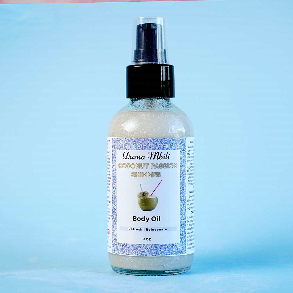 Duma Mbili Coconut Passion Shimmer Body Oil, 4 oz pump bottle on a blue background.