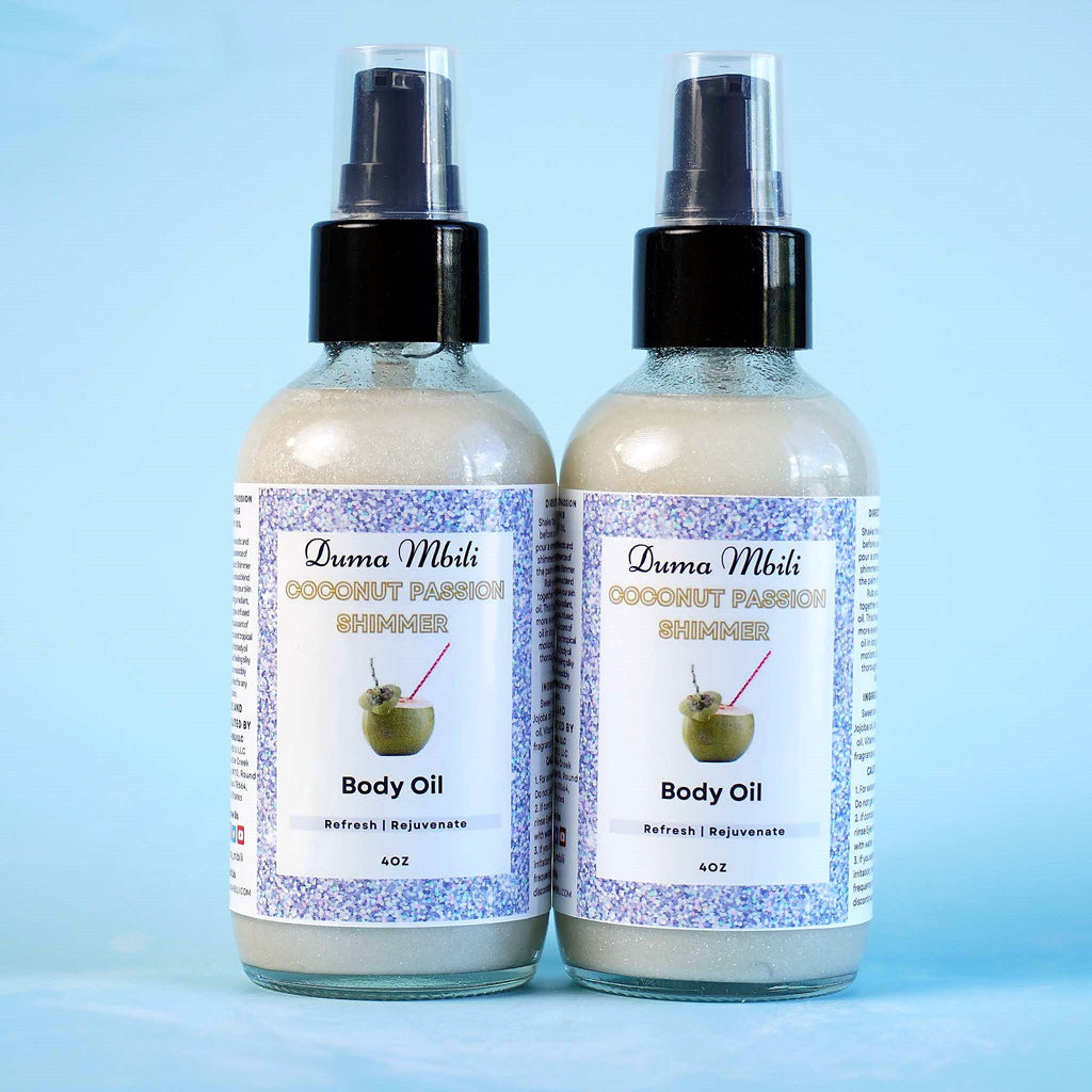 Two Duma Mbili Coconut Passion Shimmer Body Oil bottles standing side by side.